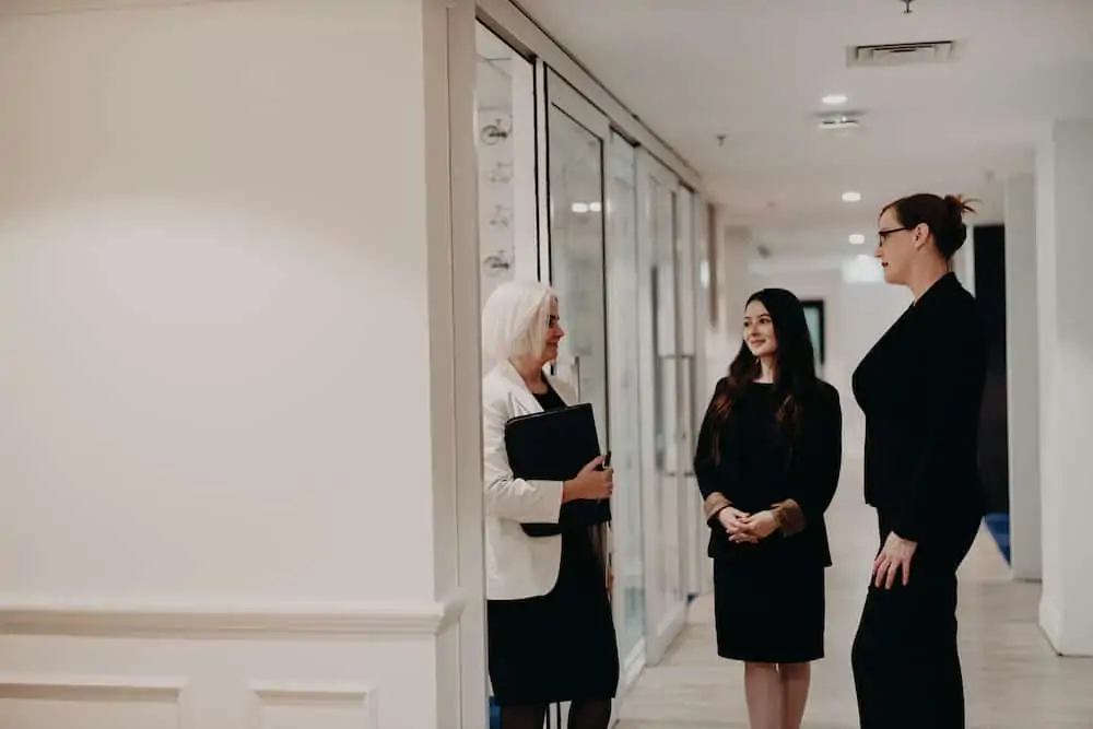 lawyers discussing a case in a corridor