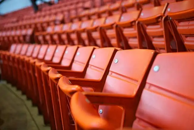 A detailed view of the stadium seating representative of that present at McDonald Jones Stadium, the focal point of the recent Venues NSW v Kane legal case, showcasing tiered rows of seats without handrails