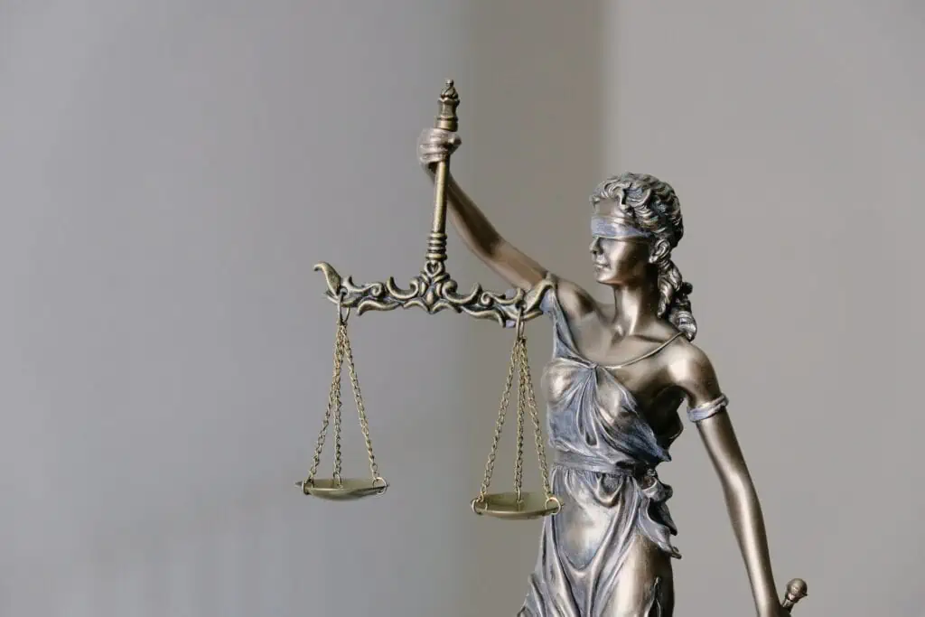 A scale of justice atop a judge's gavel representing the careful scrutiny and balanced judgement in the case "Ford v Nominal Defendant [No 2] [2023] QCA 181"